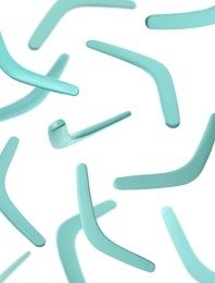 Image of Many turquoise boomerangs falling on white background