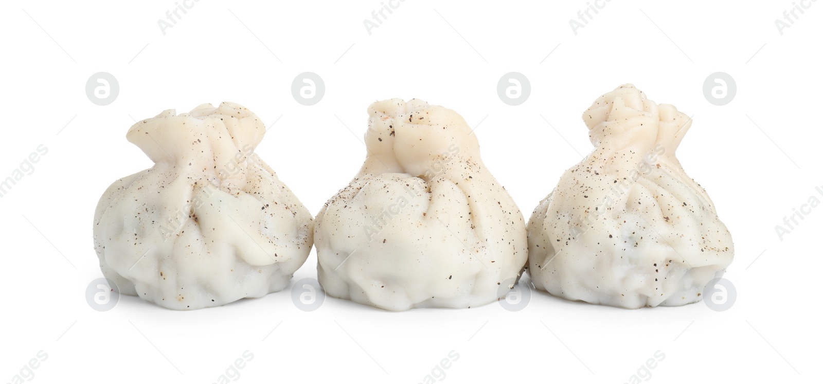 Photo of Three tasty khinkali (dumplings) and spices isolated on white. Georgian cuisine