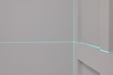 Photo of Cross lines of laser level on light walls