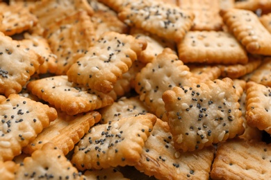 Photo of Many delicious crackers as background, closeup view