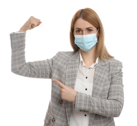 Photo of Businesswoman with protective mask showing muscles on white background. Strong immunity concept
