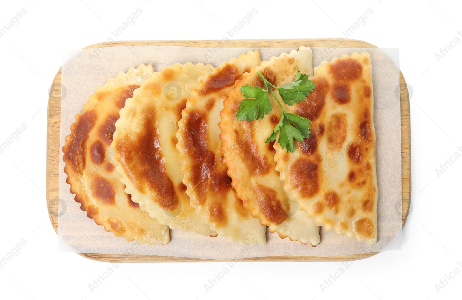 Photo of Board with delicious fried chebureki and parsley isolated on white, top view