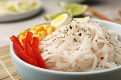 Photo of Bowl with rice noodles and vegetables, closeup