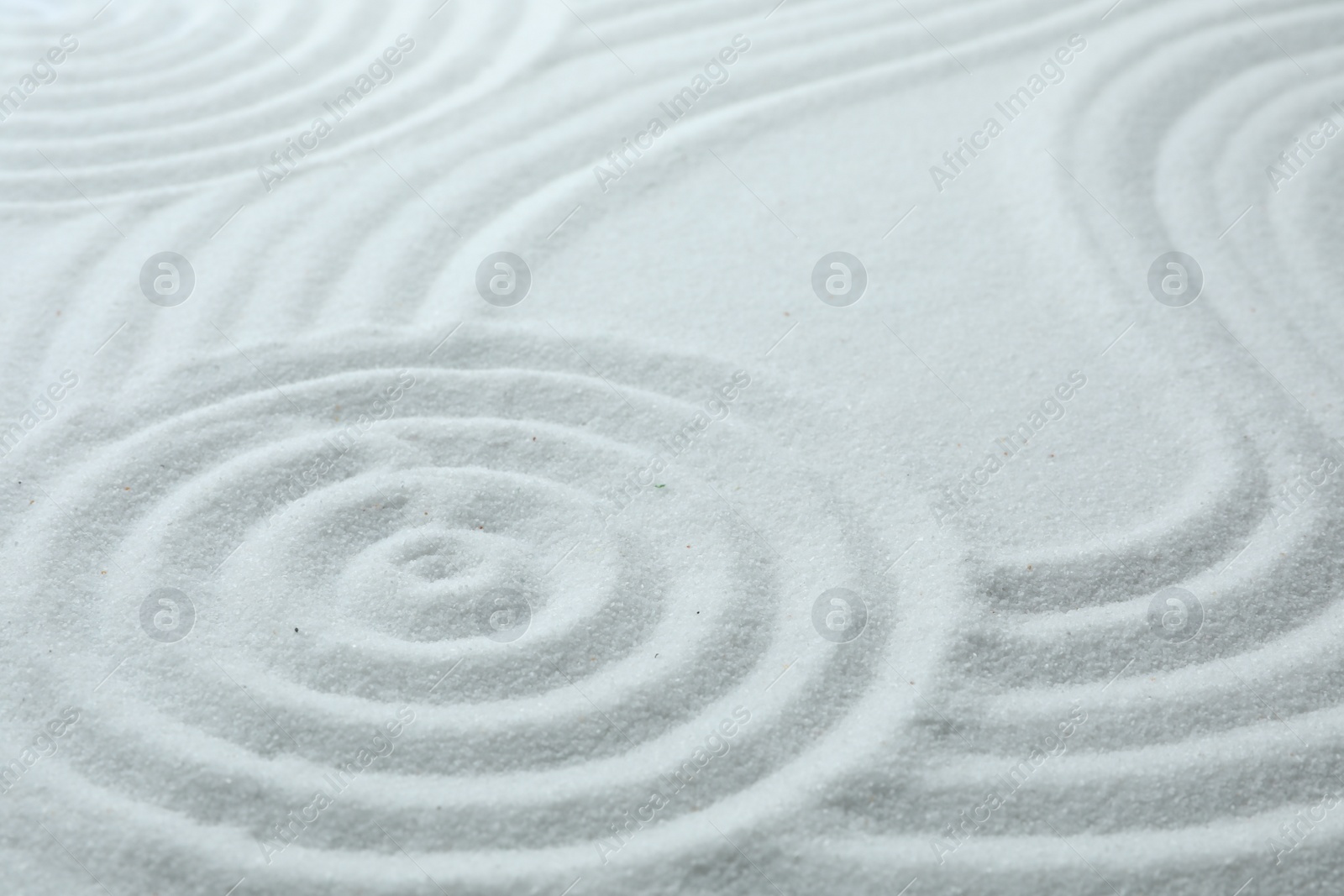 Photo of White sand with pattern as background. Zen, meditation, harmony