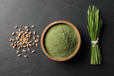 Photo of Wheat grass powder in bowl, seeds and fresh sprouts on grey textured table, flat lay
