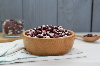 Photo of Bowl with dry kidney beans on white table