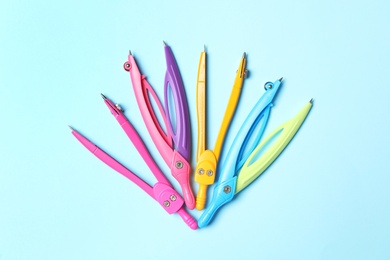 Photo of Colorful school stationery on light blue background, flat lay. Back to school