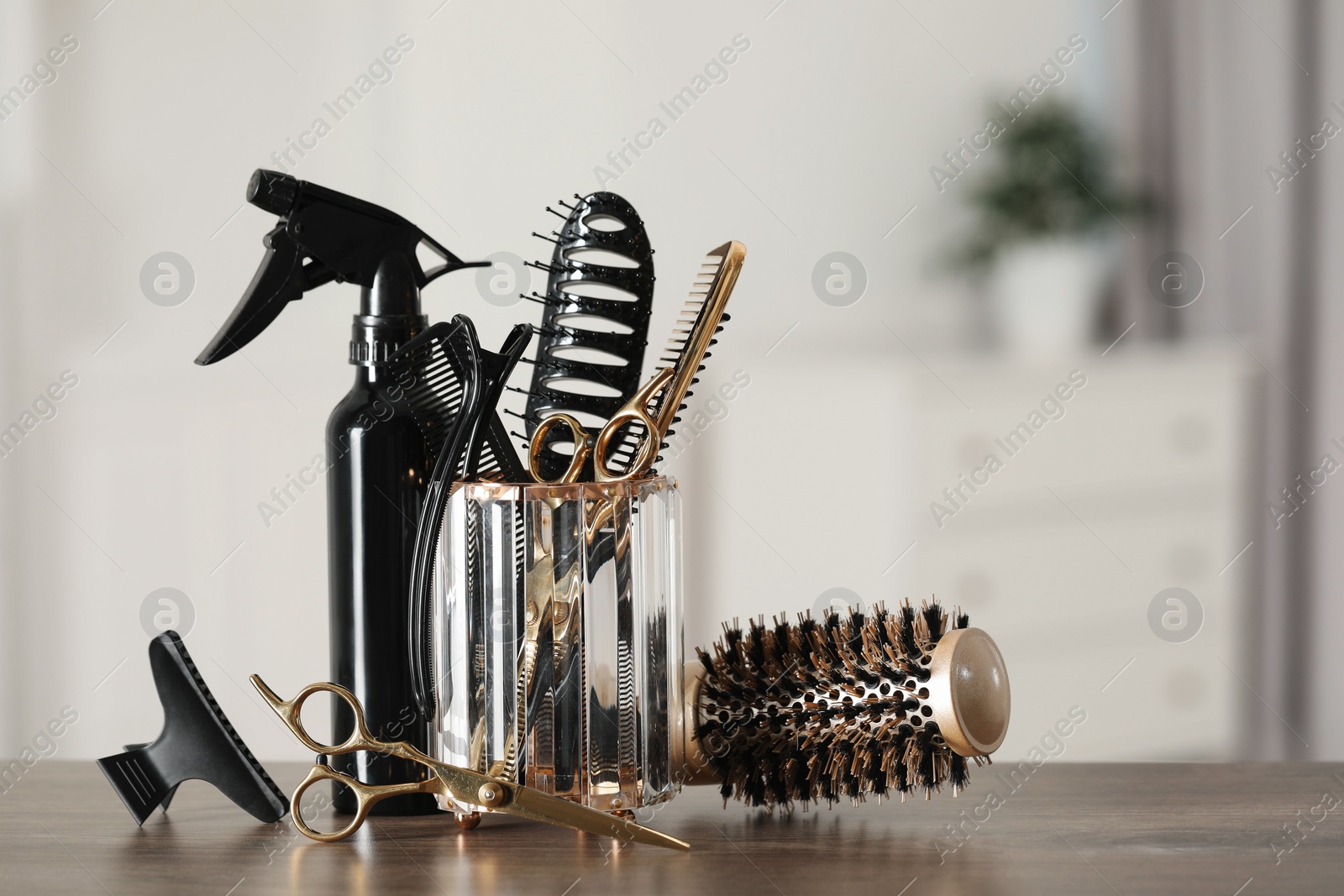 Photo of Set of hairdresser tools on table in salon, space for text