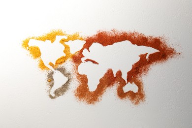 World map of different spices on white textured table, flat lay