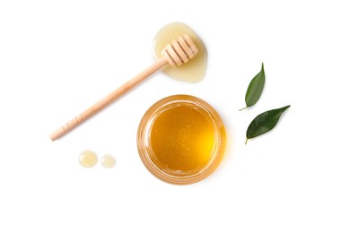 Photo of Tasty honey in glass jar, leaves and dipper on white background, flat lay