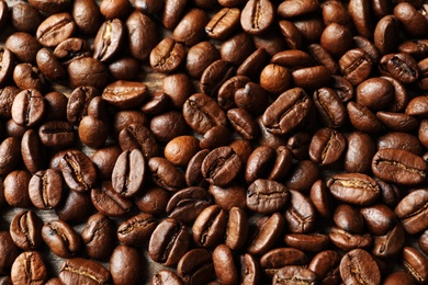 Roasted coffee beans as background, top view