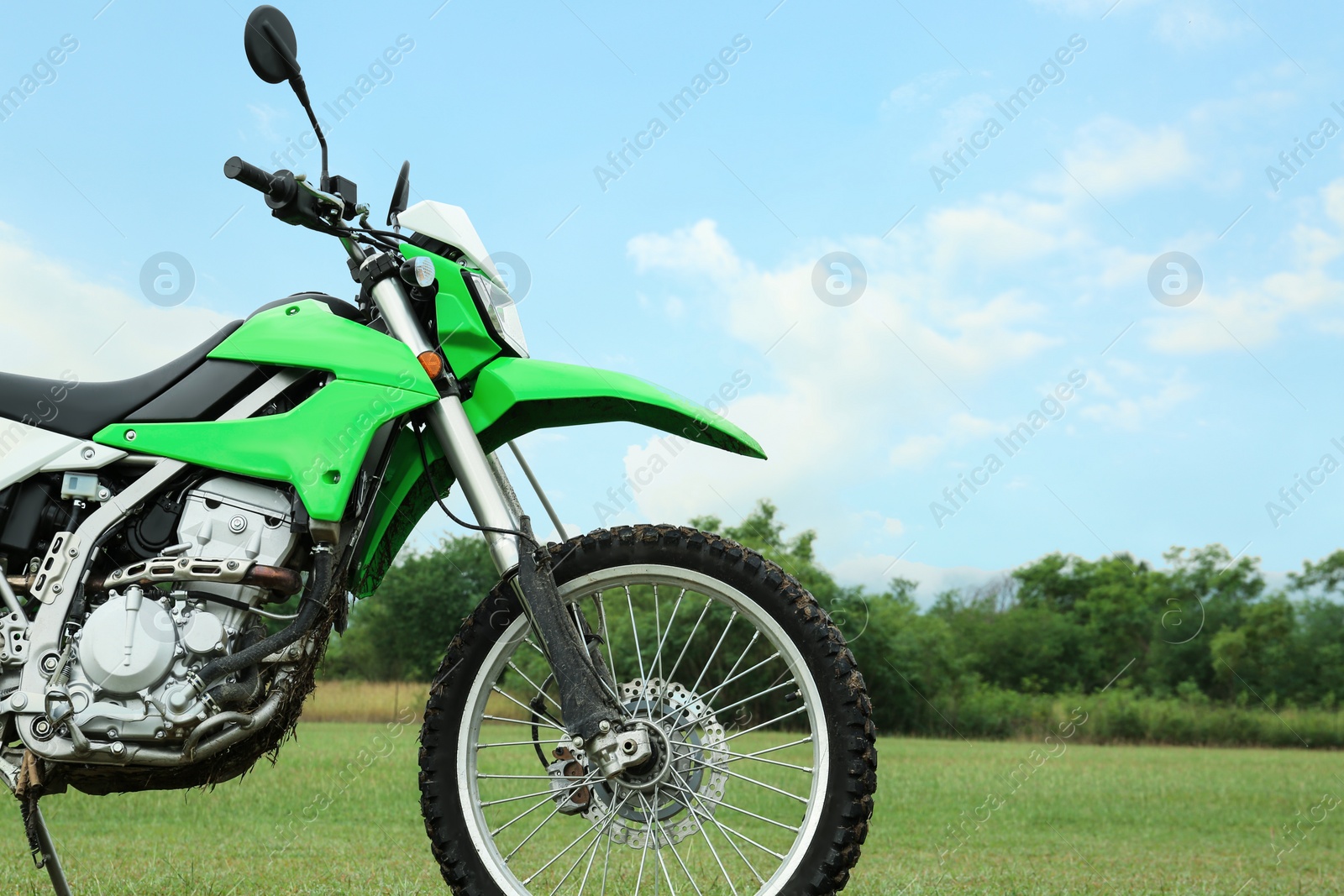 Photo of Stylish green cross motorcycle outdoors, space for text