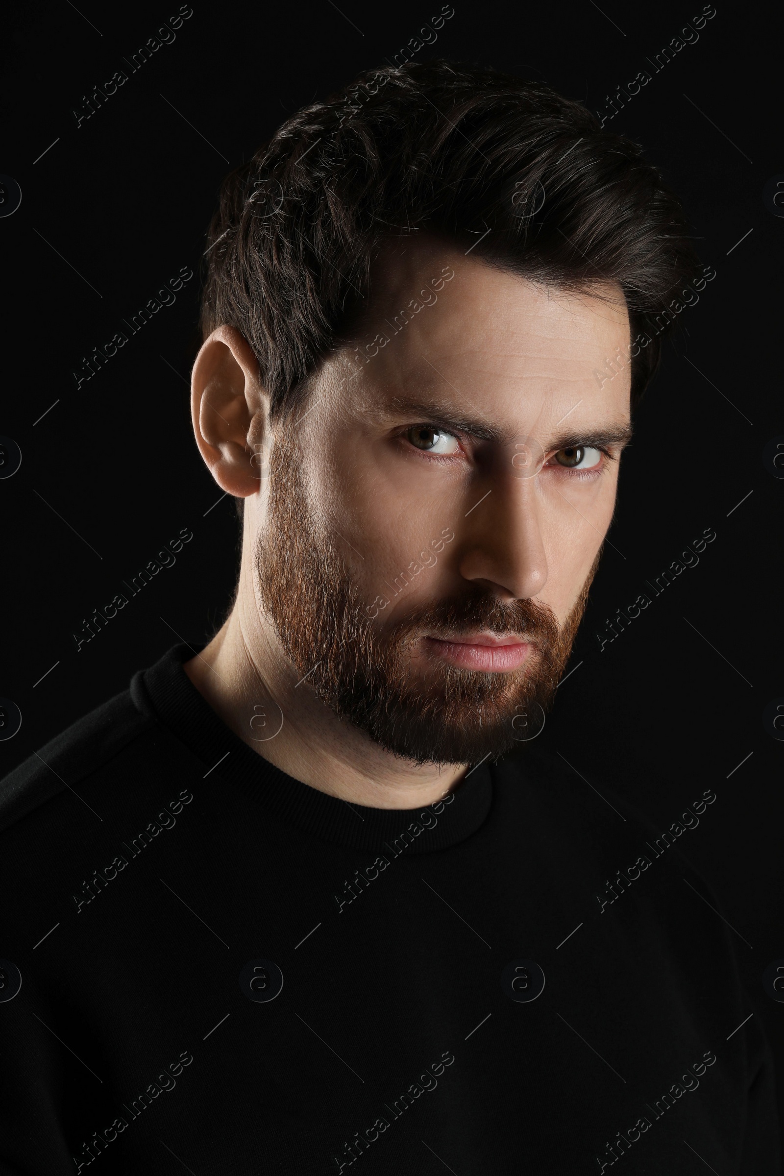 Photo of Evil eye. Man with scary eyes on black background