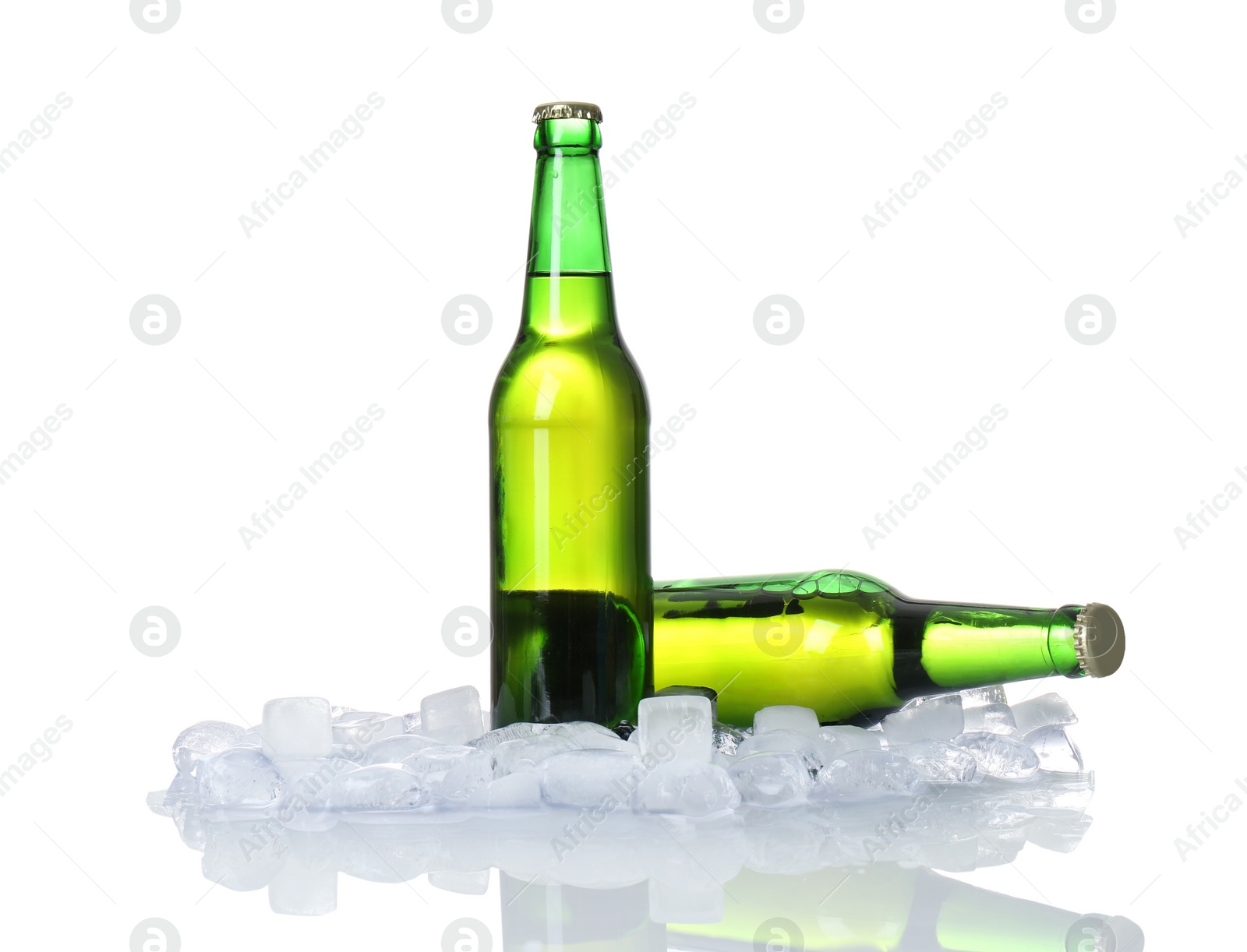 Photo of Bottles of beer and ice cubes on white background