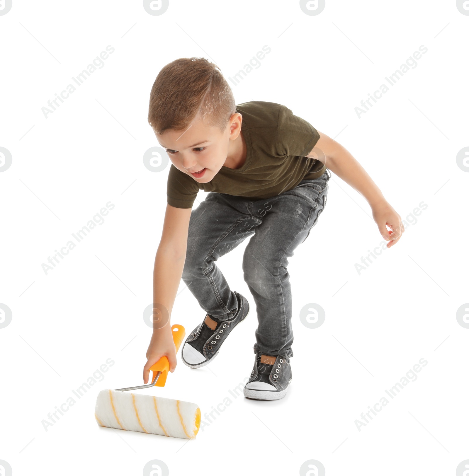 Photo of Little child painting something with roller brush on white background