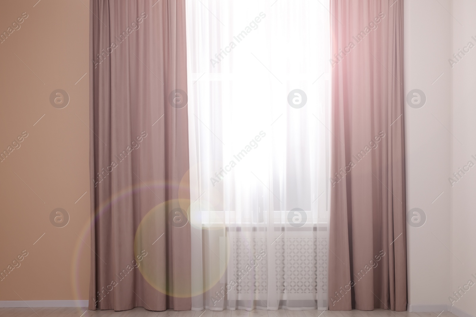 Photo of Window with beautiful curtains in room. Interior design