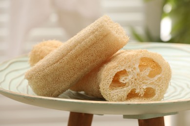 Loofah sponges on coffee table indoors, closeup