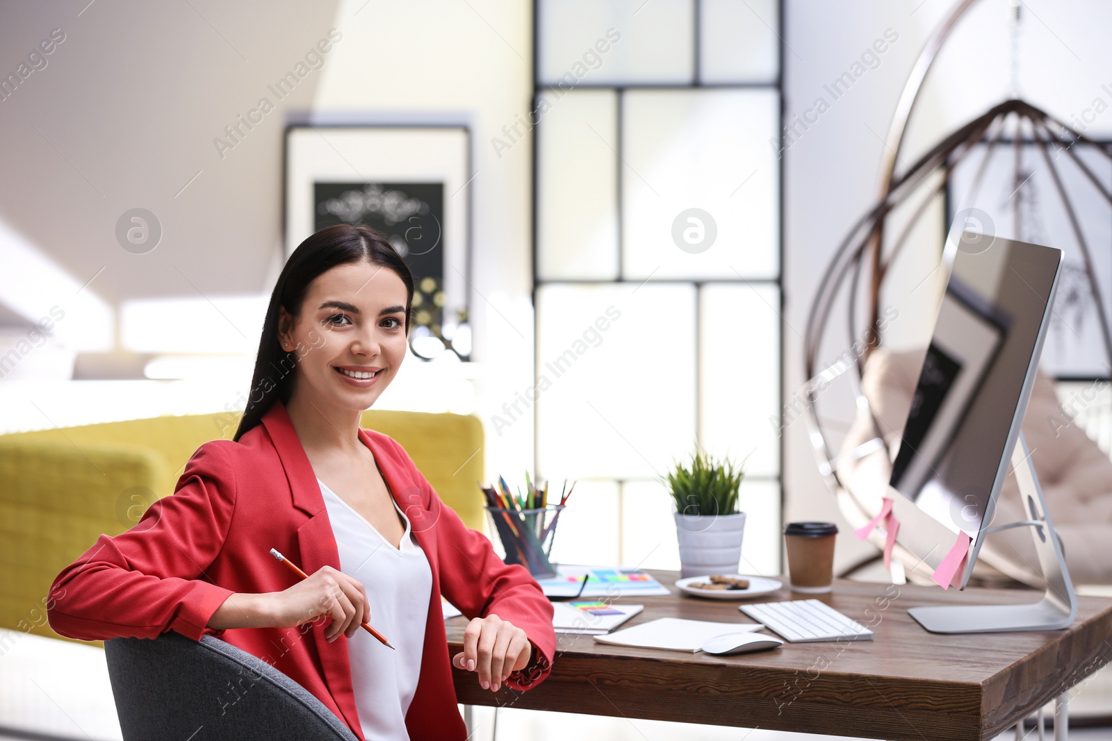 Photo of Female designer working at desk in office