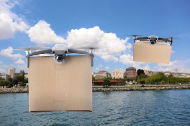 Image of Modern drones with carton boxes flying above sea on sunny day. Delivery service 