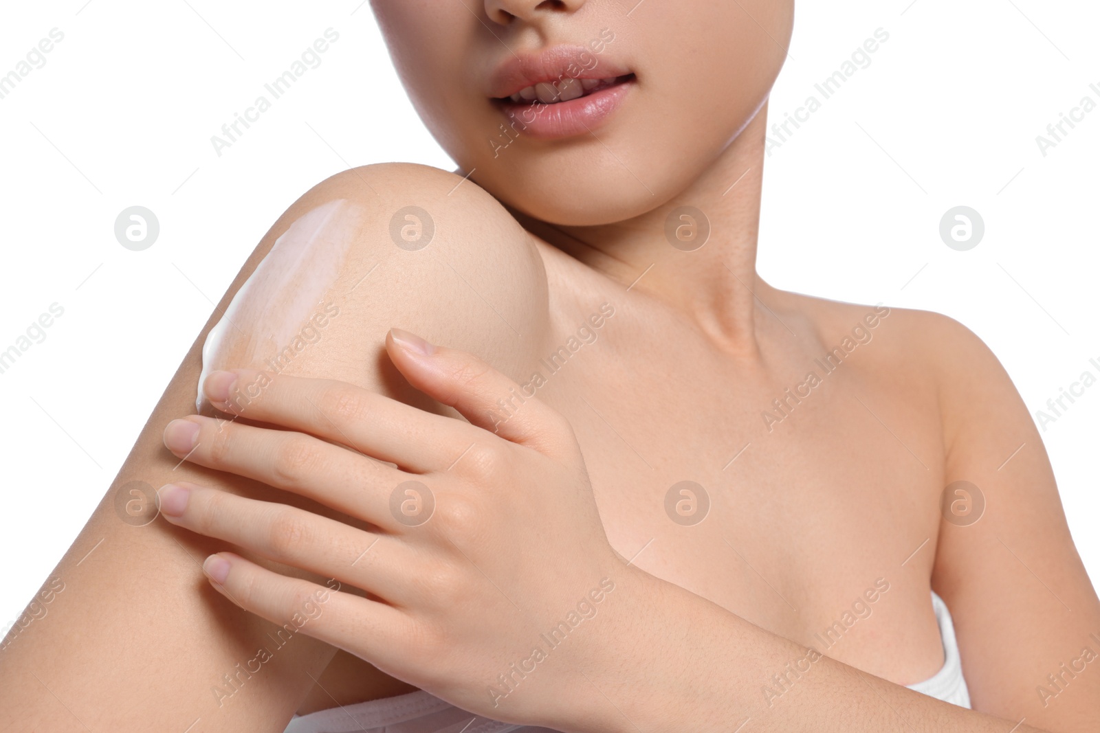 Photo of Beautiful young woman with body cream smear on shoulder against white background, closeup