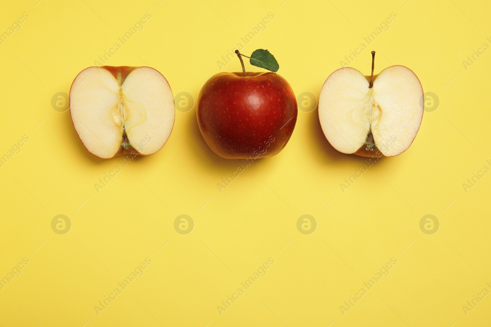 Photo of Flat lay composition with ripe juicy red apples on yellow background, space for text