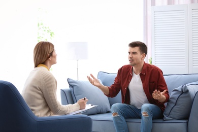 Female psychologist with client in office