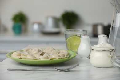 Photo of Delicious dumplings served on table in kitchen