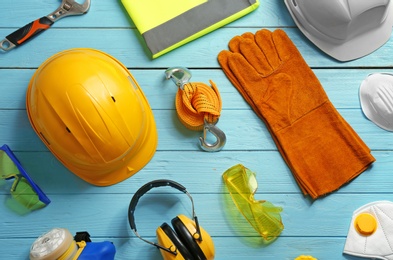 Photo of Flat lay composition with safety equipment on wooden background