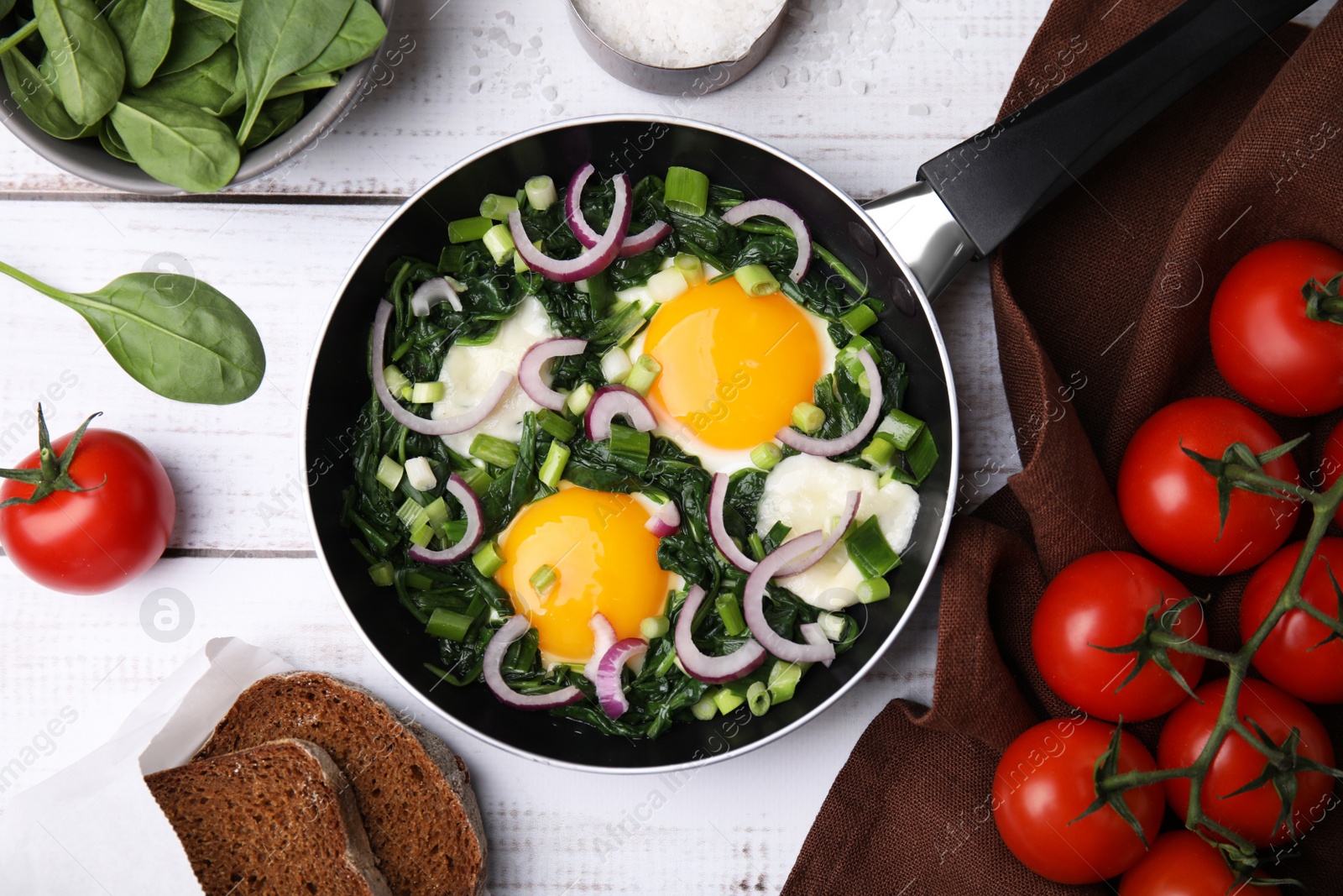 Photo of Flat lay composition with tasty Shakshouka and ingredients on white wooden table