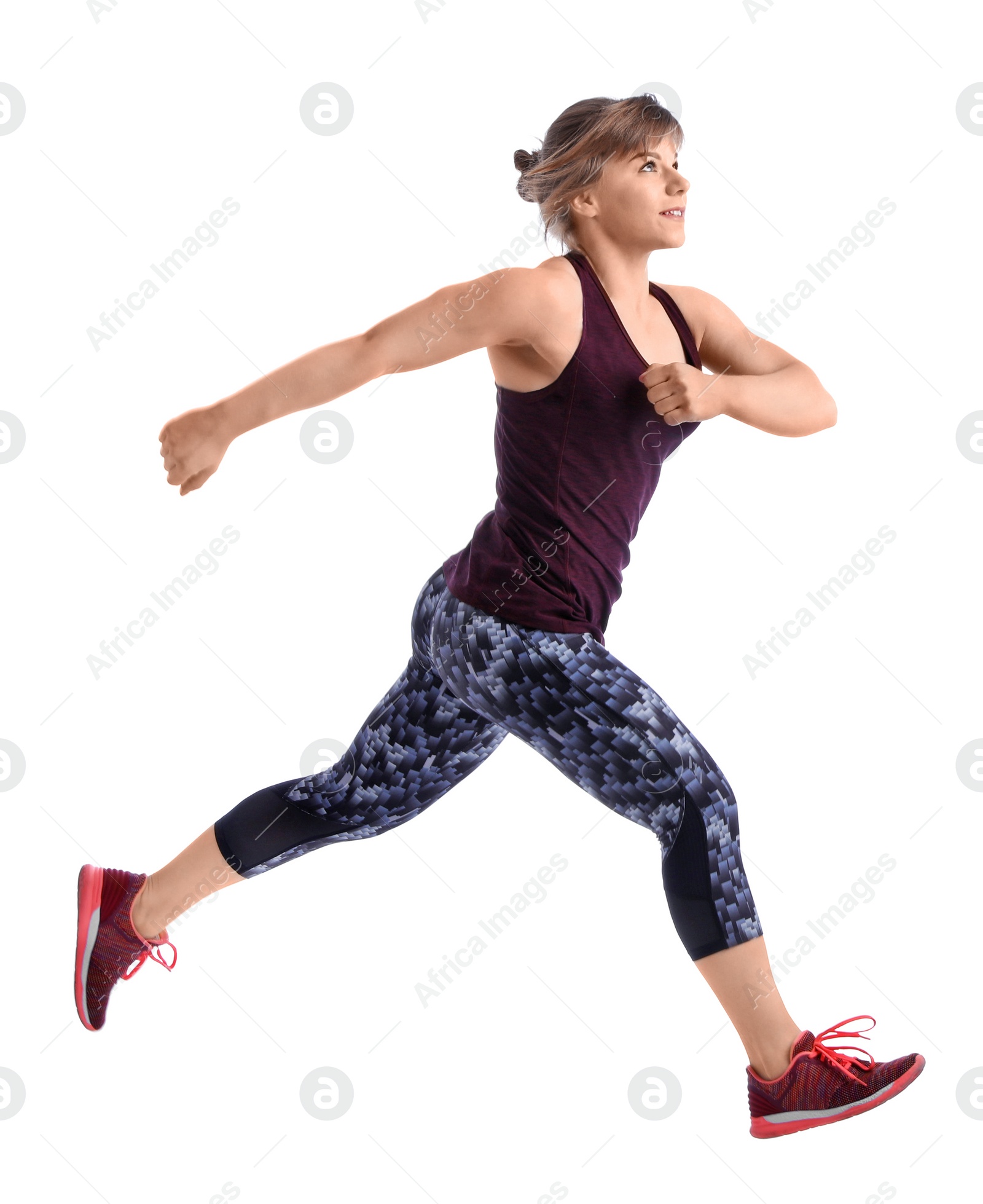 Photo of Young woman in sportswear running on white background