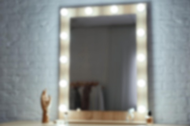 Blurred view of makeup mirror on table in dressing room