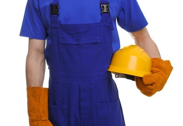 Young man holding yellow hardhat on white background, closeup. Safety equipment