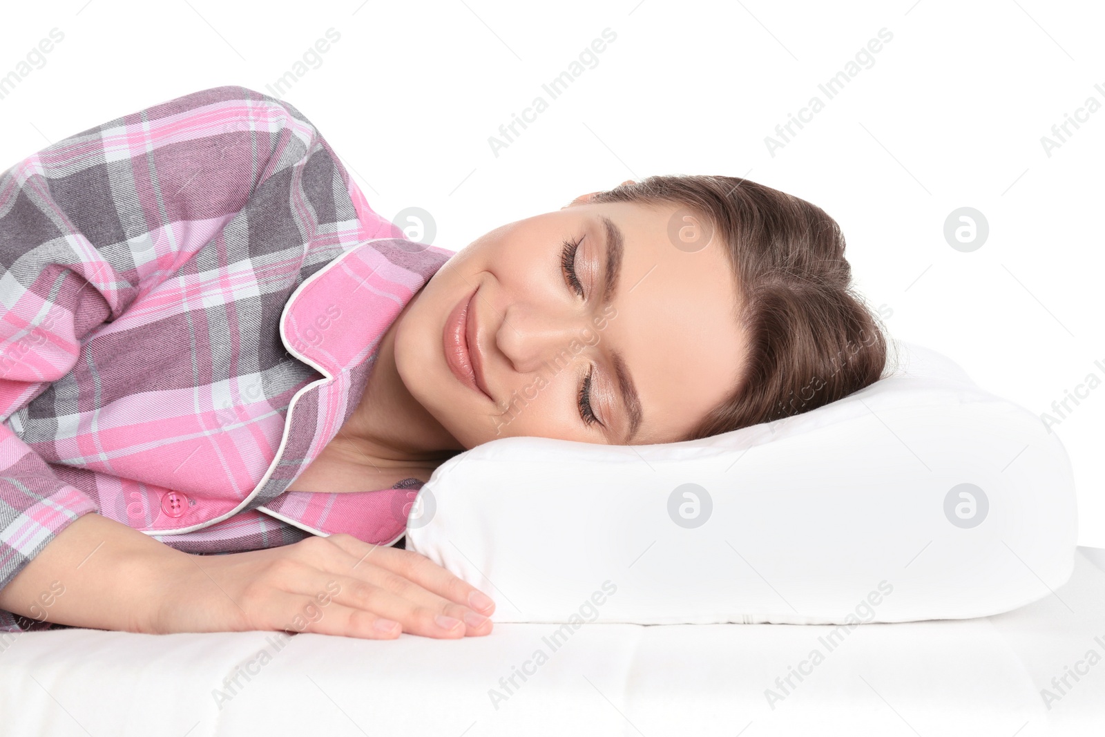 Photo of Young woman sleeping on orthopedic pillow against white background, closeup