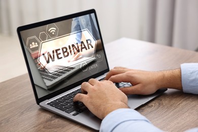 Webinar. Man using laptop at table, closeup