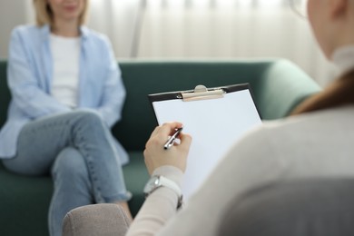 Photo of Professional psychotherapist working with patient in office, closeup