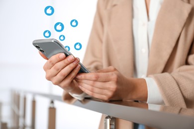 Young woman using smartphone indoors, closeup. Social media