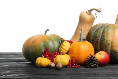 Photo of Happy Thanksgiving day. Composition with pumpkins and berries on black wooden table against white background
