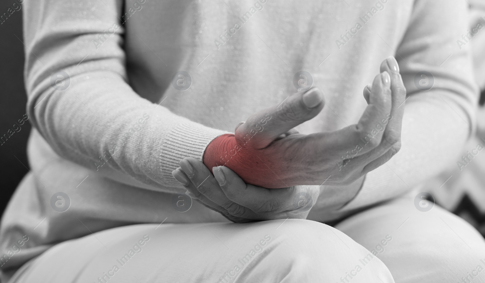 Image of Woman suffering from pain in wrist, closeup. Black and white effect. Banner design