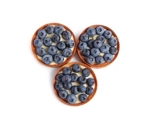 Photo of Tartlets with fresh blueberries isolated on white, top view. Delicious dessert