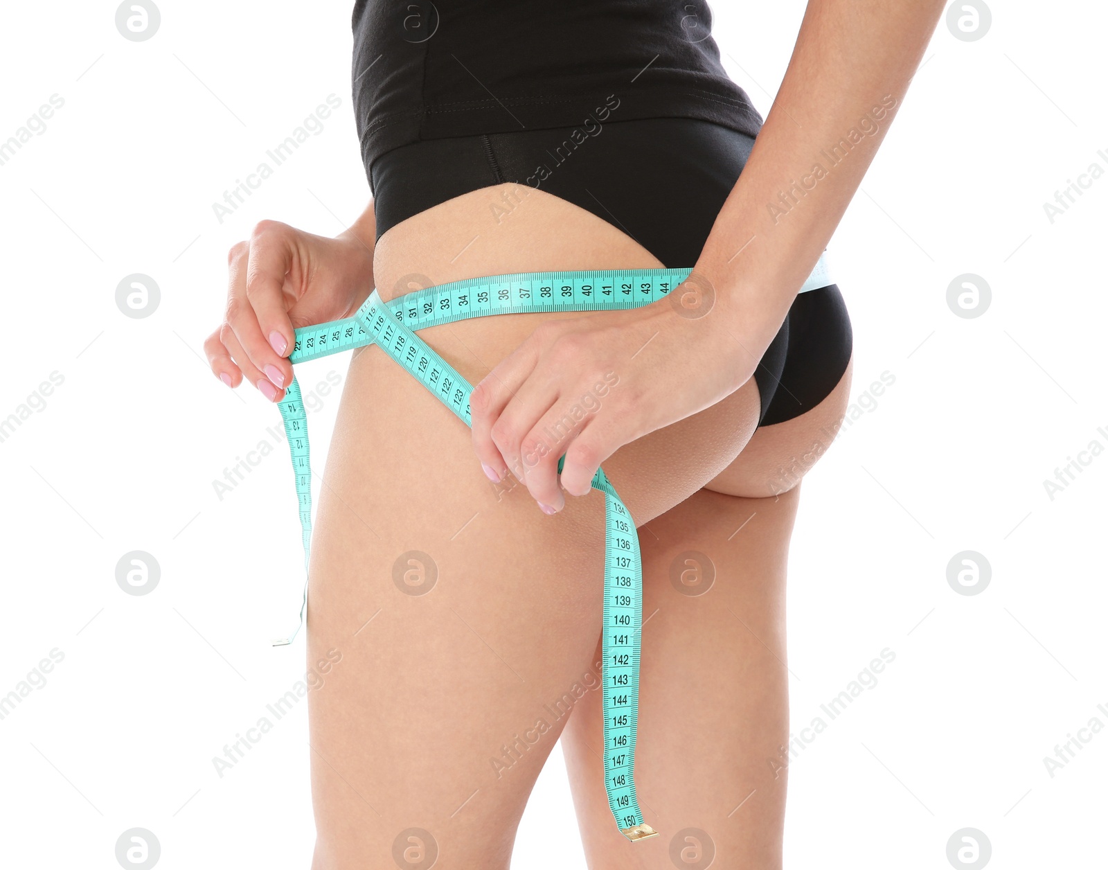 Photo of Slim woman measuring her hips on white background, closeup. Weight loss