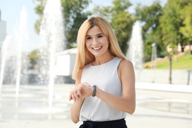 Portrait of beautiful blonde woman outdoors on sunny day