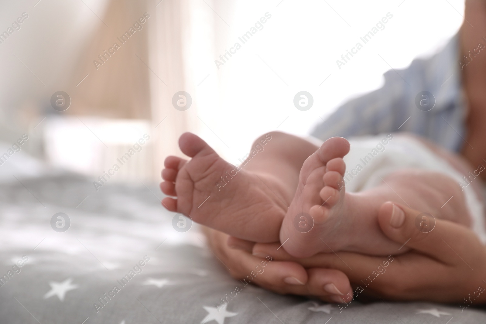 Photo of Mother and her little baby on bed, closeup