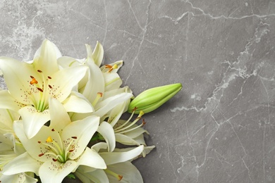 Photo of Flat lay composition with lily flowers on grey background