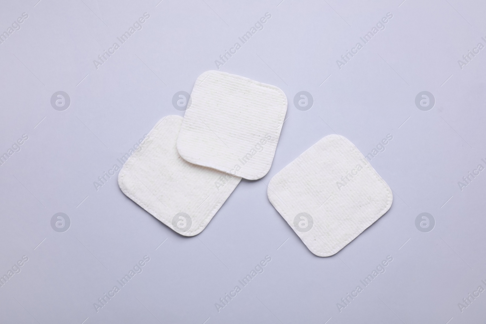 Photo of Clean cotton pads on light grey background, flat lay