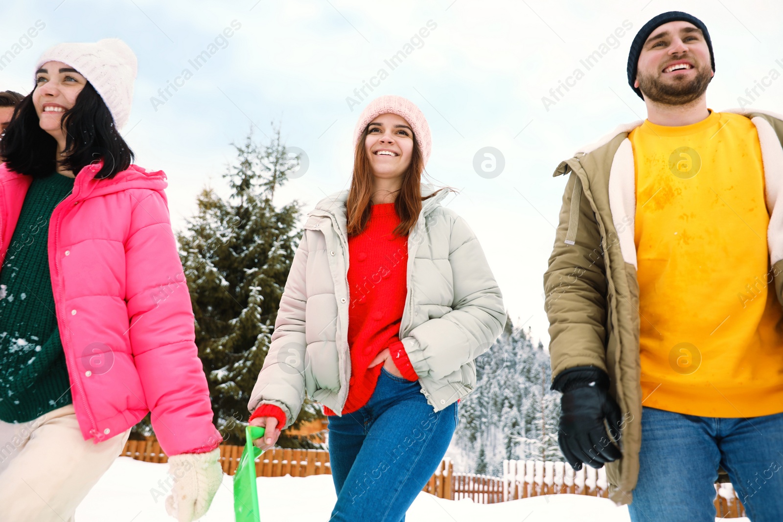 Photo of Group of friends outdoors on snowy day. Winter vacation