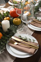 Photo of Beautiful autumn table setting. Plates, cutlery, glasses, pumpkins and floral decor