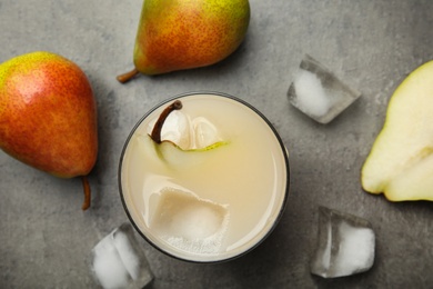 Photo of Fresh pear juice, ice cubes and fruits on grey table, flat lay