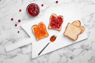 Photo of Toasts with various jam on light background, top view