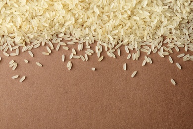Photo of Parboiled rice on color background, top view with space for text