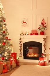 Living room with fireplace and Christmas decorations. Festive interior design